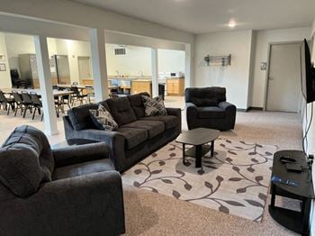 Main community room with comfortable seating area with cable tv and large gathering area with appliances